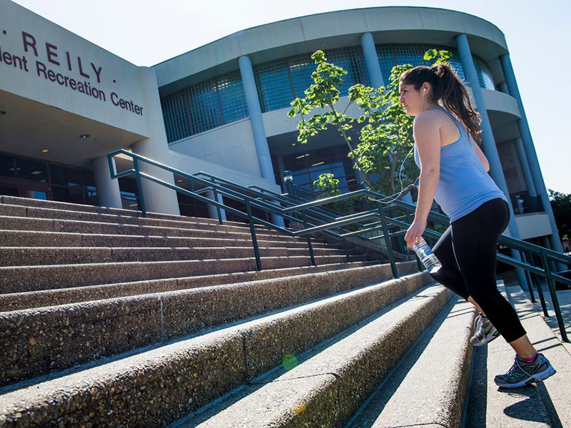 A Tulane student runs up the steps at the Reily Student Recreation Center