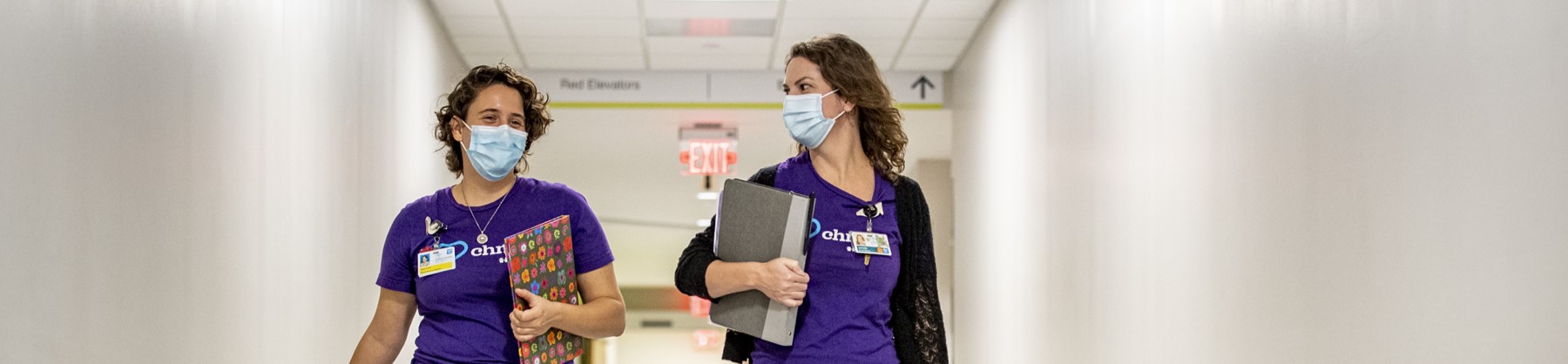 Two students walk together through a hospital.