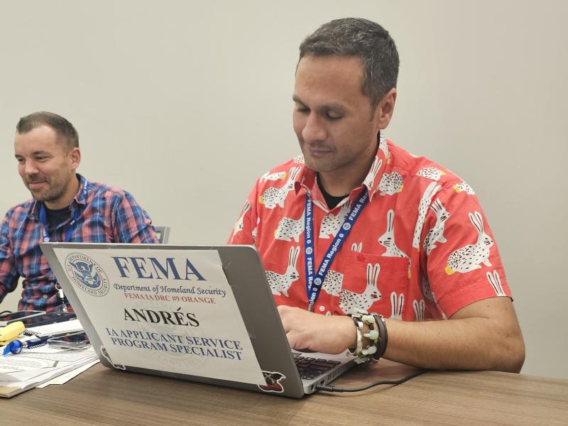 Andy Melendez Salgado types at his FEMA computer.