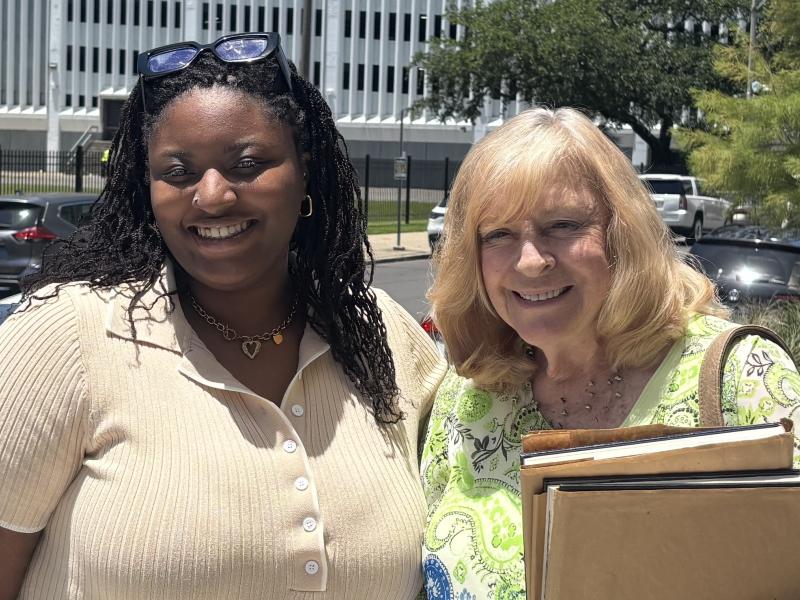 and Jeanne Ashley (right) stand outdoors, smiling.
