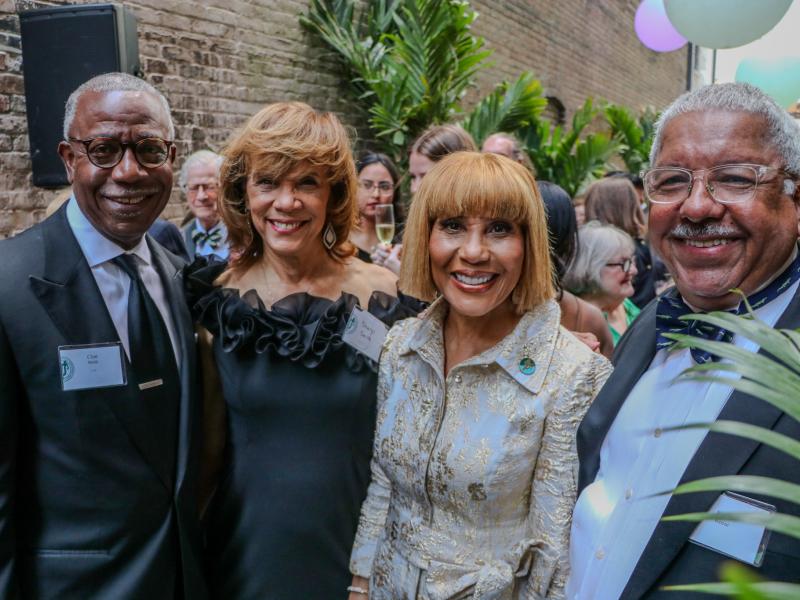 Four smiling adults, including MSW/MPH alumna Dottie Reese, in formal attire at the Tulane University Alumni Awards Gala.