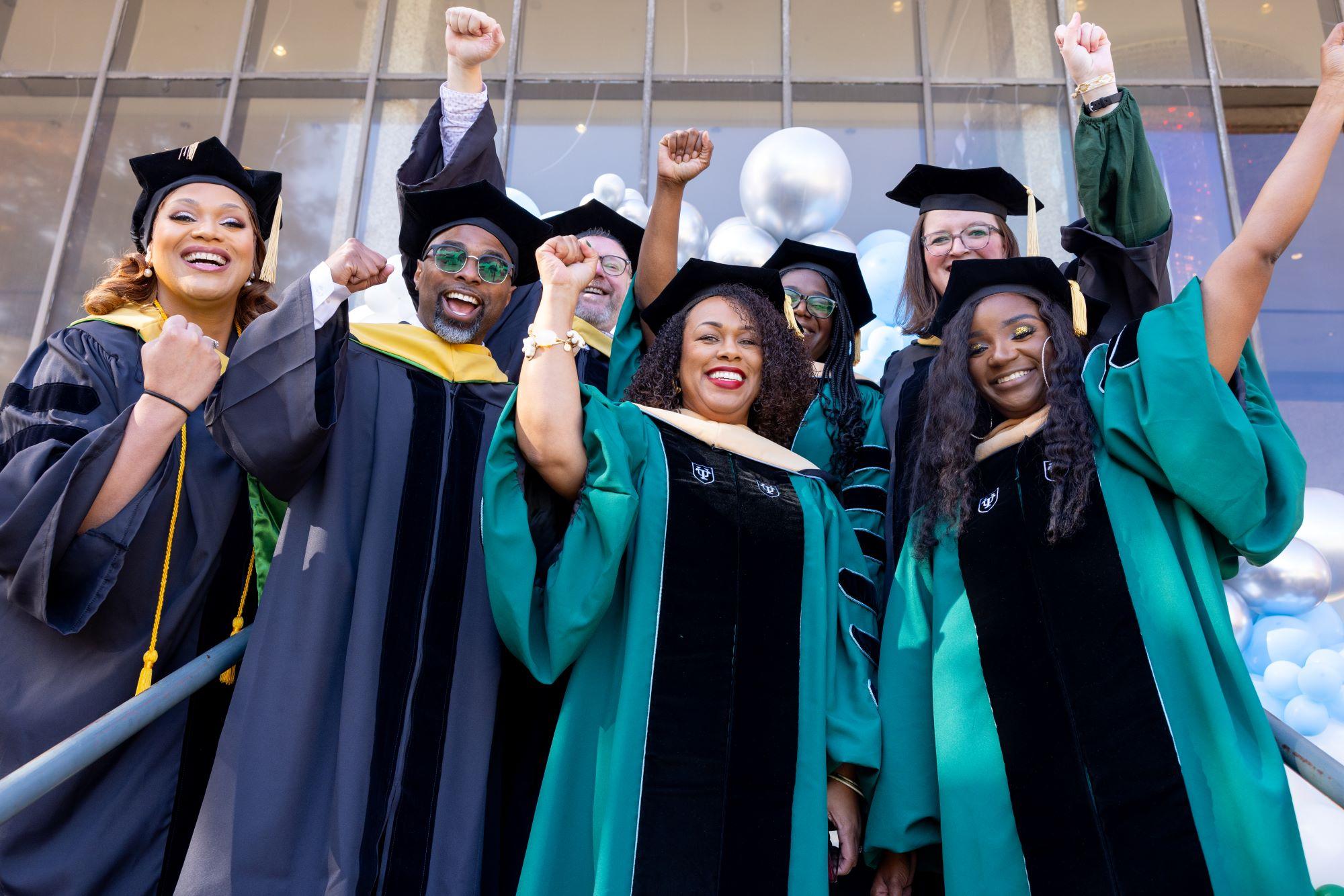 The 2022 DSW graduates raise their fists after graduation.