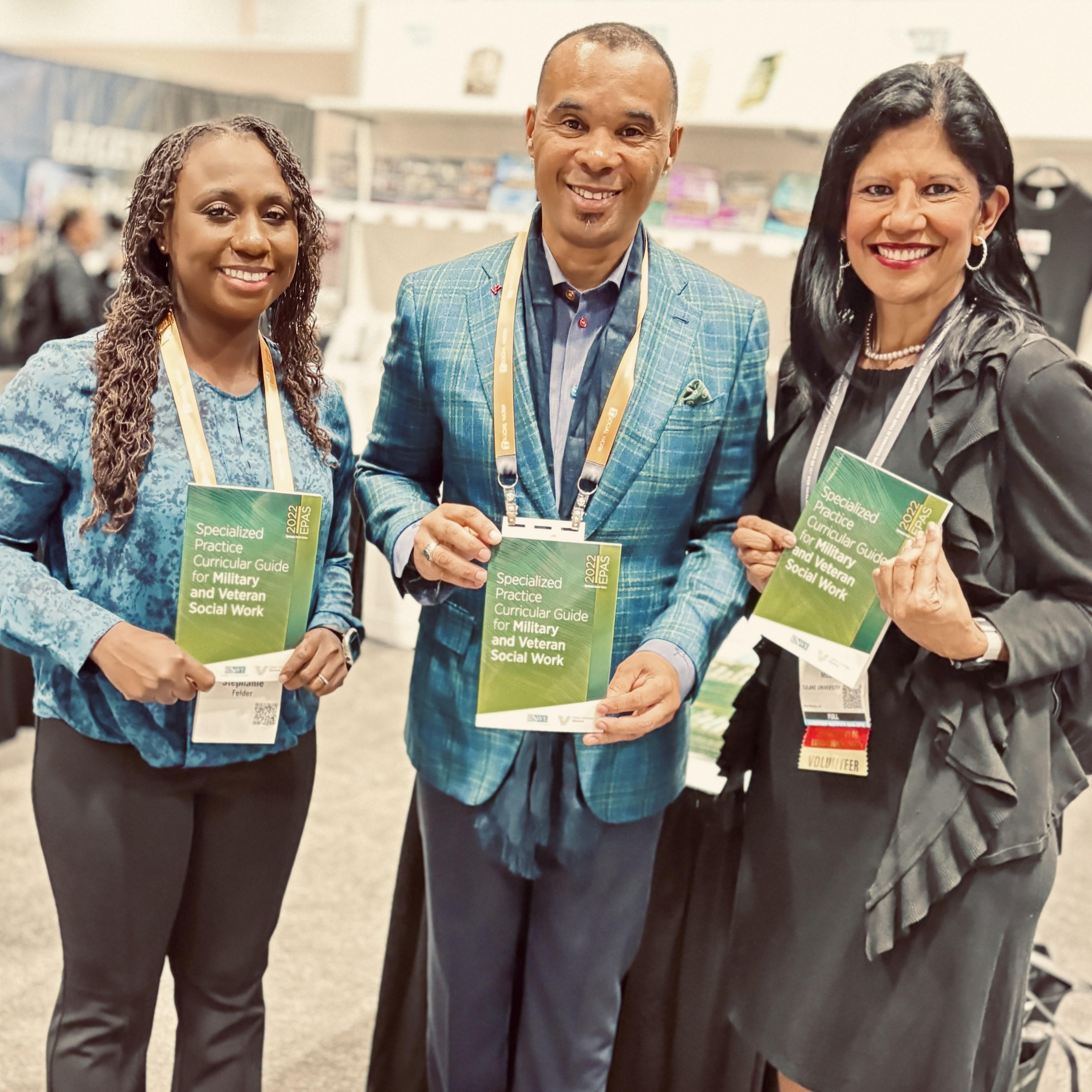 Dr. Stephanie Felder, Samuel Odom, and Kathy Levy-Oqueli McGraw show off copies of the CSWE EPAS Specialized Curricular Guide for Military and Veteran Social Work