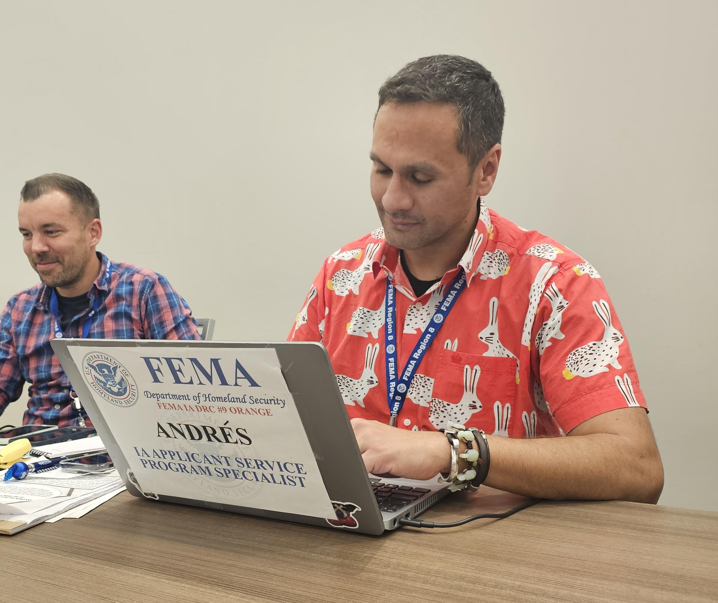 Andy Melendez Salgado types at his FEMA computer.