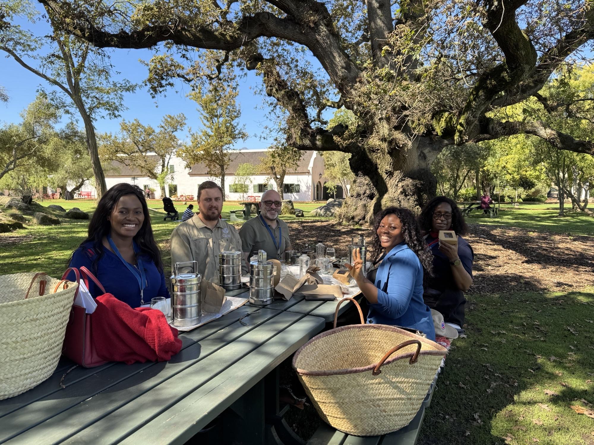 The team sits at a picnic bench.