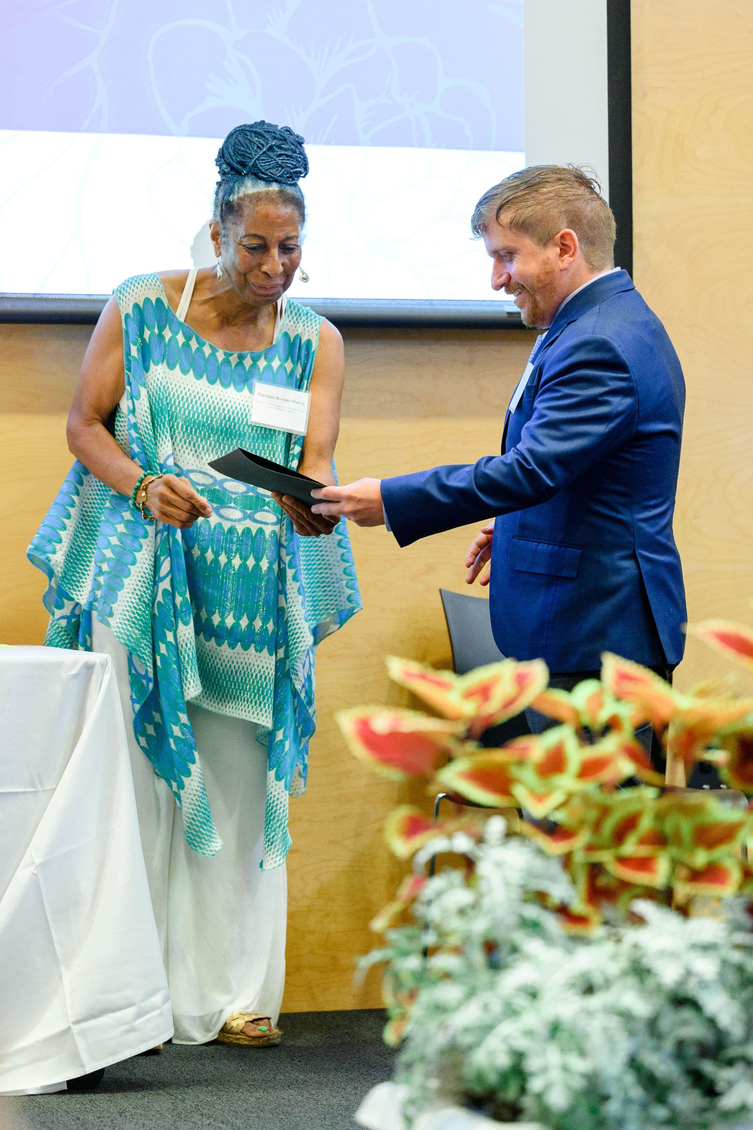 Carolyn Barber-Pierre hands Stephen Randle his award.