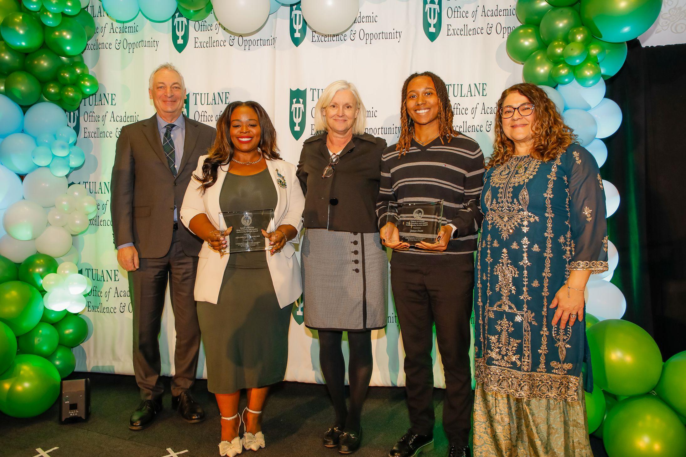 Two students hold glass Dr. King Student Leadership Awards. They stand beside Robin Foreman, Dean Susan Davies, and Dr. Anneliese Singh.