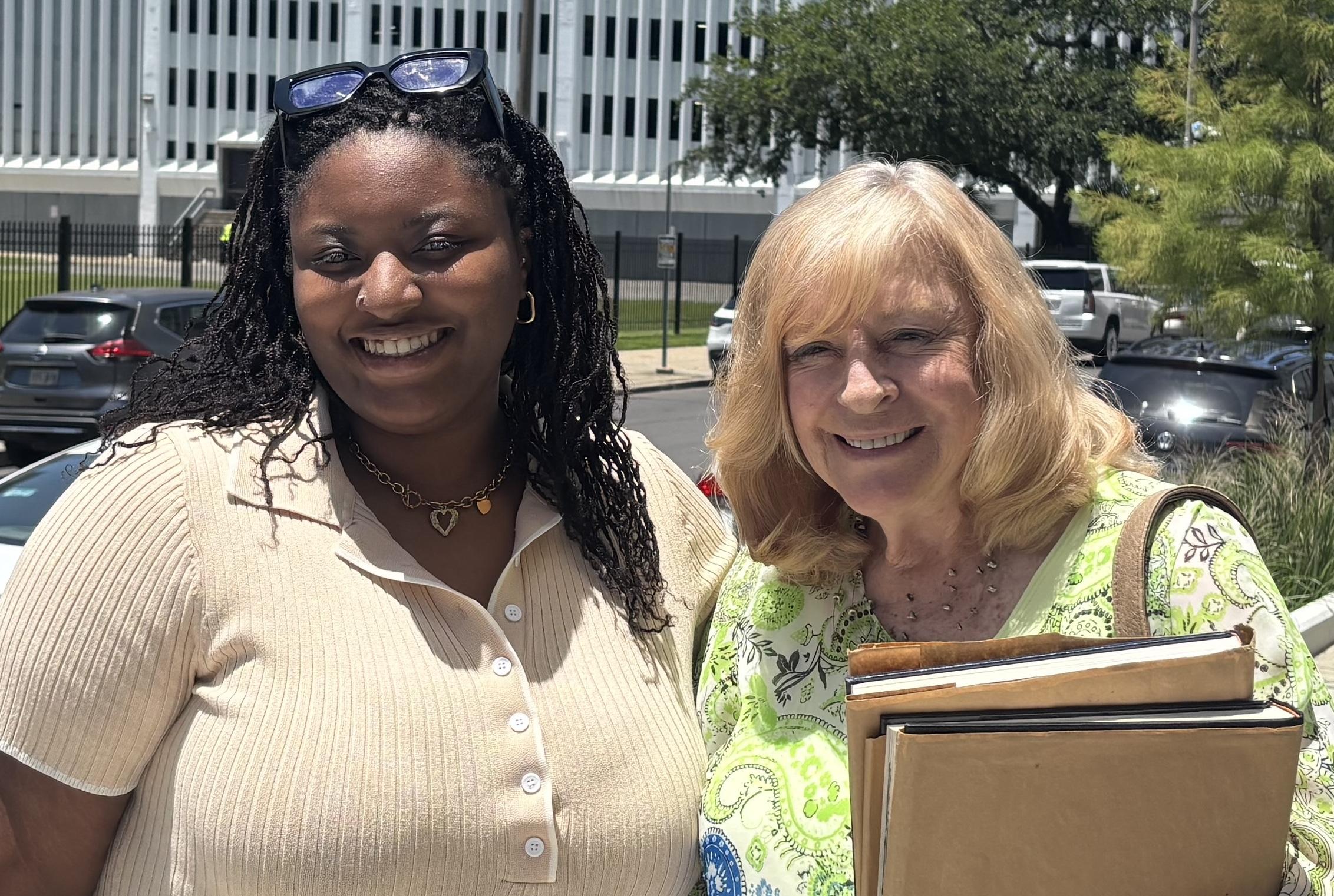 Kennadi Robinson (left) and Jeanne Ashley (right) stand outdoors, smiling.