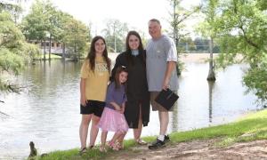Jana Guyewski-Lautigar stands with her family.
