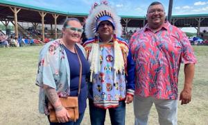 Dr. Jennifer Roberston, Chief Gregory Desjarlais, and Marcel Desjarlais smile
