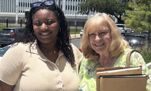 and Jeanne Ashley (right) stand outdoors, smiling.